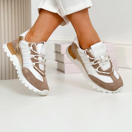 Stylizowane ujęcie – beżowo-białe sneakersy Artiker w ruchu, złote detale – artiker buty sneakersy
